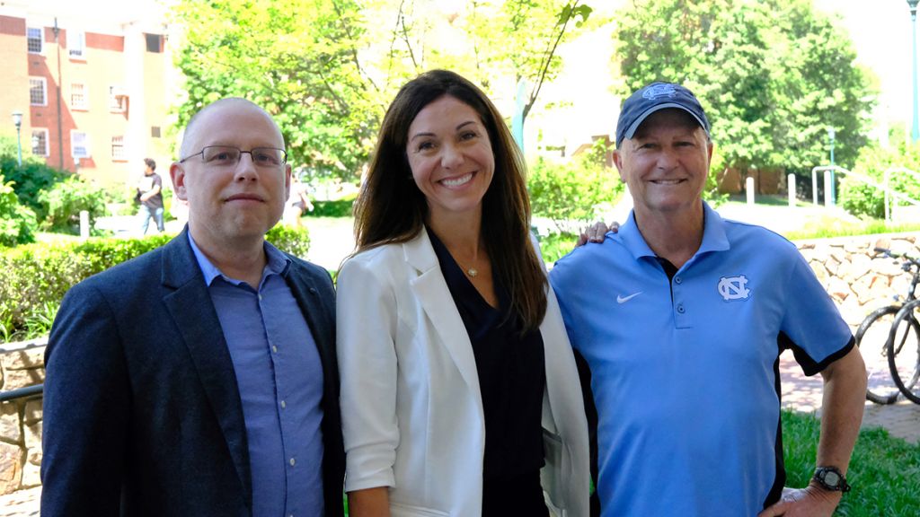 Jeff Greene, Erianne Weight and Anson Dorrance pose for the camera